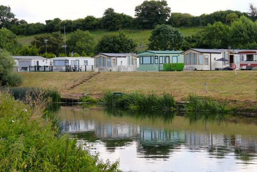 Holiday homes at Dovecote, seen across the River Avon